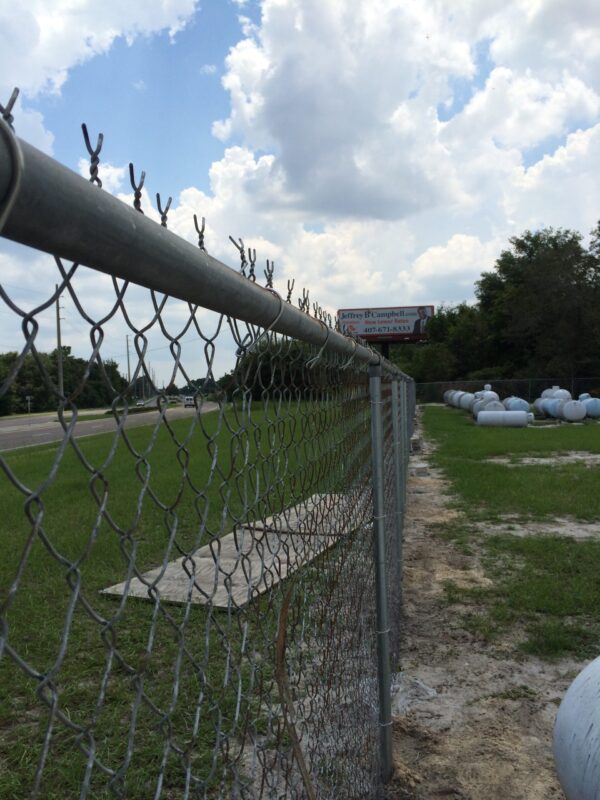Commercial chain link fence repair completed in Orlando, FL with new posts and restored fence alignment.