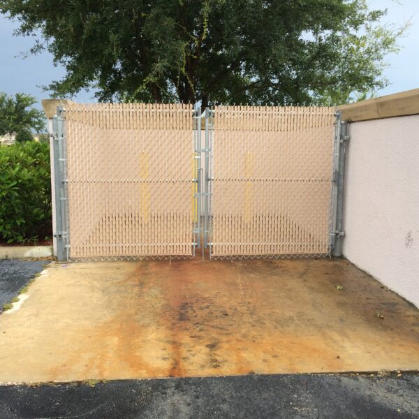 Commercial dumpster enclosure with double chain link privacy gates installed in Orlando, FL.
