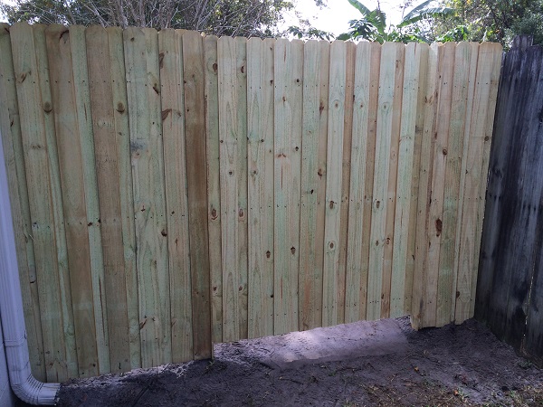 New pressure-treated wood privacy fence gate replacing deteriorated gate in Orlando FL